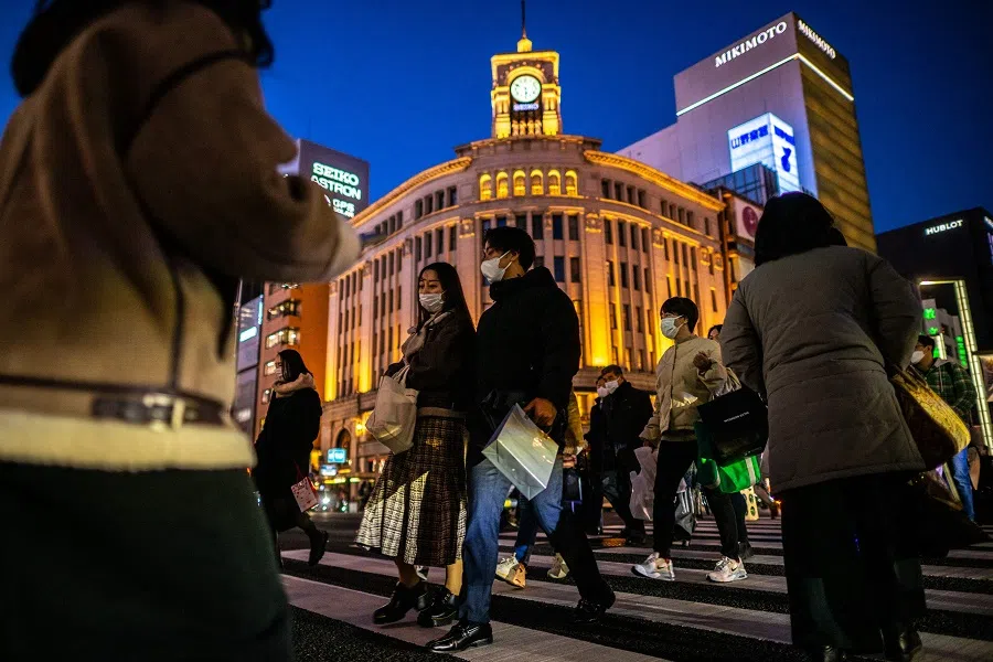 People walk through the Ginza district in Tokyo, Japan, on 21 February 2023. (Philip Fong/AFP)