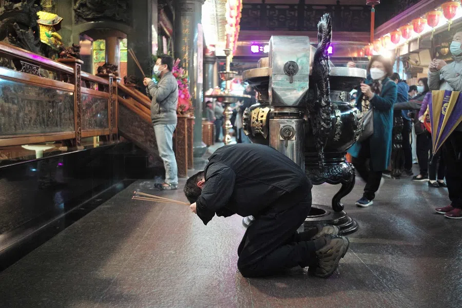 Local residents pray at the Taoist Guandu temple in Taipei, Taiwan, on 31 January 2022. (Sam Yeh/AFP)