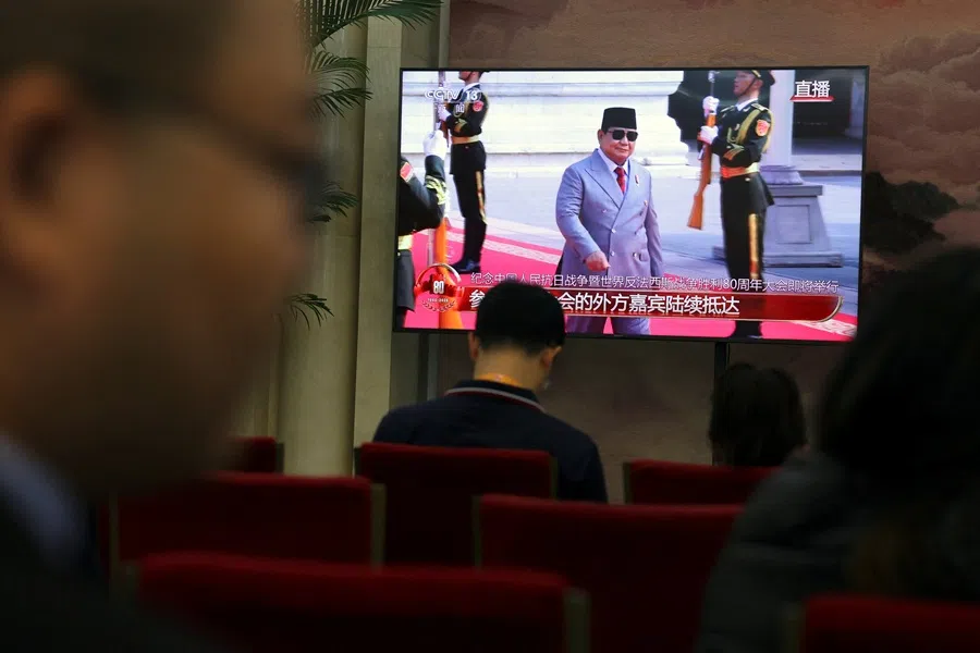 A TV screen shows Indonesia President Prabowo Subianto arriving for a military parade marking the 80th anniversary of the end of World War Two, at a waiting room for media personnel in Beijing, China, on 3 September 2025. (Florence Lo/Reuters)