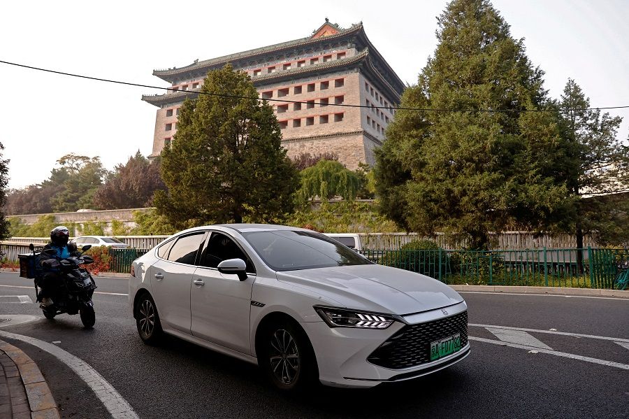 A BYD electric vehicle (EV) Qin moves on a street in Beijing, China, on 31 October 2023. (Tingshu Wang/Reuters)