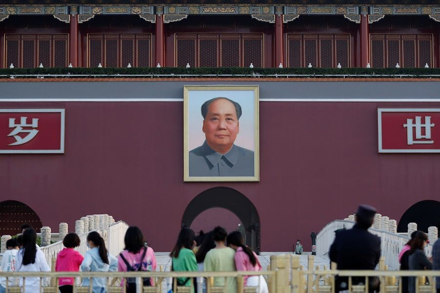 Visitors are seen near the portrait of late Chinese chairman Mao Zedong on Tiananmen Gate, on the day of the closing session of the National People's Congress, in Beijing, China, on 28 May 2020. (Carlos Garcia Rawlins/Reuters)