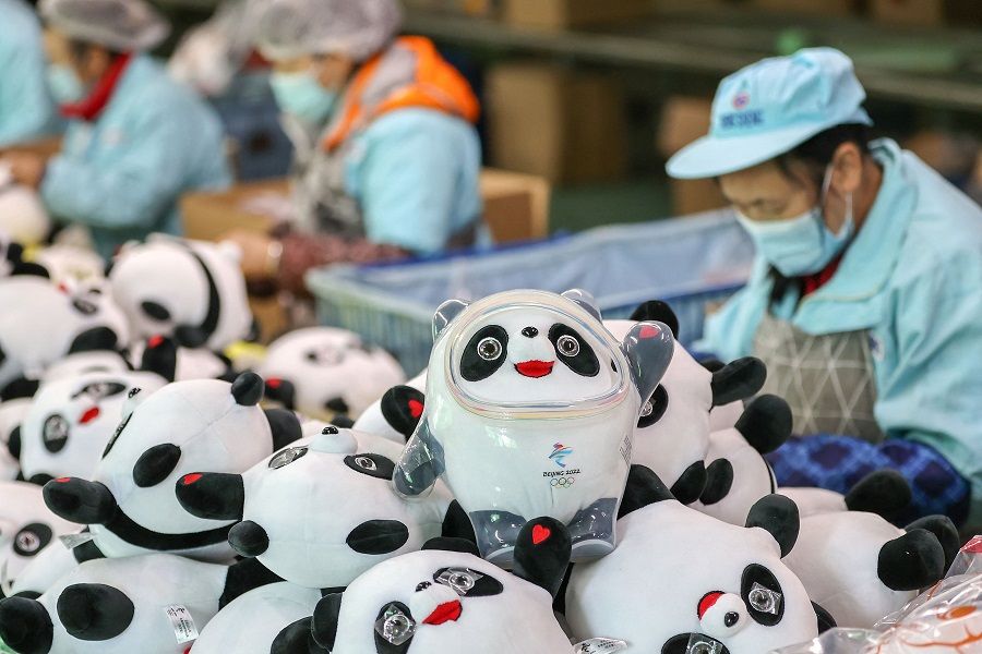 This photo taken on 8 February 2022 shows employees working on stuffed toys of 2022 Beijing Winter Olympic Games mascot Bing Dwen Dwen at a factory in Jinjiang, Fujian province, China. (AFP)