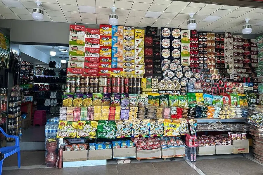 A store next to a customs station in Hekou county in Southwest China’s Yunnan province sells snacks, slippers, bead strings and other goods imported from Vietnam, 3 November 2024. 