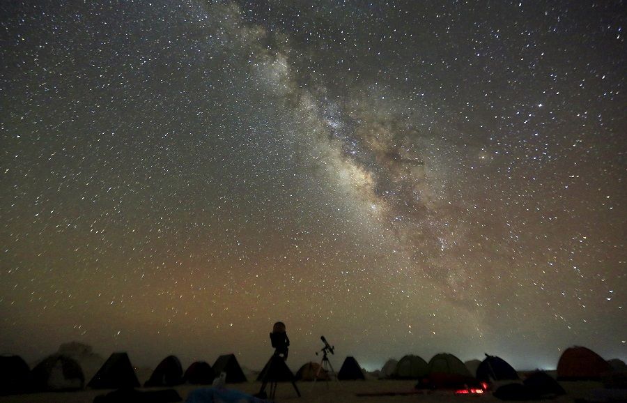 The Milky Way is seen in the night sky around telescopes and camps of people over rocks in the White Desert north of the Farafra Oasis southwest of Cairo, Egypt, 16 May 2015. (Amr Abdallah Dalsh/File Photo/Reuters)