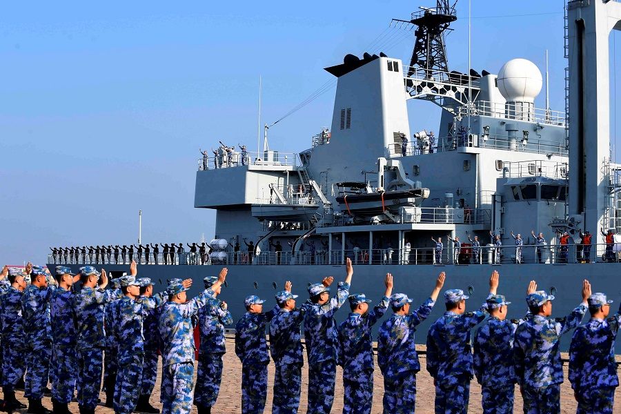 Soldiers of the Chinese People's Liberation Army (PLA) Navy take part in a ceremony as a replenishment ship sets sail to the Gulf of Aden and the waters off Somalia, from a naval port in Qingdao, Shandong province, China, 3 September 2020. (China Daily via Reuters)