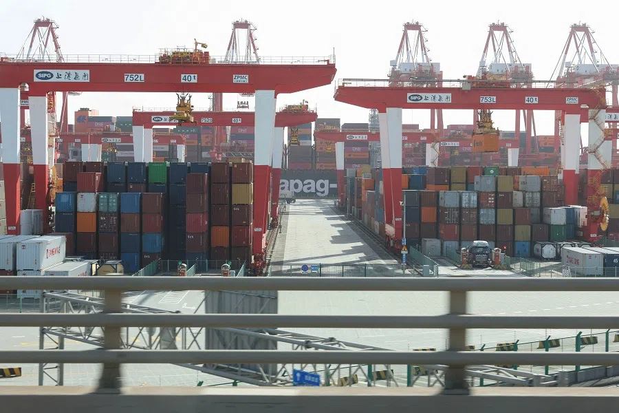 Gantry cranes stand near shipping containers at Yangshan Port outside of Shanghai, China, on 7 February 2025. (Go Nakamura/Reuters)