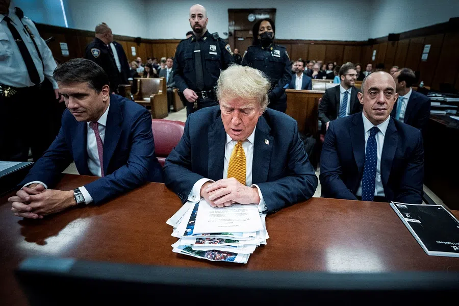 Donald Trump, flanked by attorneys Todd Blanche and Emil Bove, arrives for his criminal trial at the Manhattan Criminal Court in New York City on 29 May 2024. (Jabin Botsford/via Reuters)