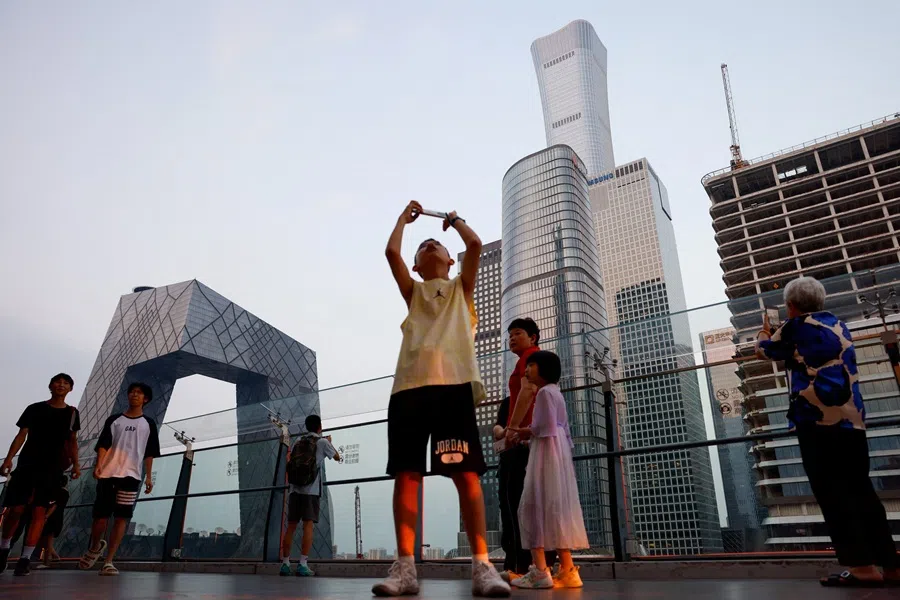 People visit a terrace of a shopping mall overlooking the central business district (CBD), in Beijing, China, on 11 August 2025.