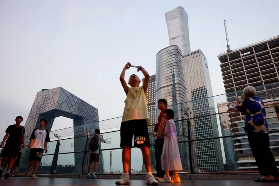 People visit a terrace of a shopping mall overlooking the central business district (CBD), in Beijing, China, on 11 August 2025. (Tingshu Wang/Reuters)