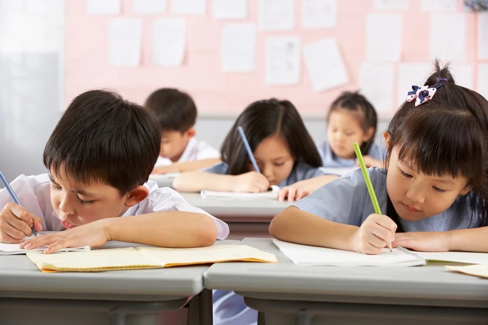 Students working at their desks in a school classroom. (iStock)