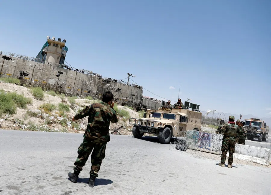 Afghan soldiers stand guard at a checkpoint outside the US Bagram air base, on the day the last of American troops vacated it, in Parwan province, Afghanistan on 2 July 2021.