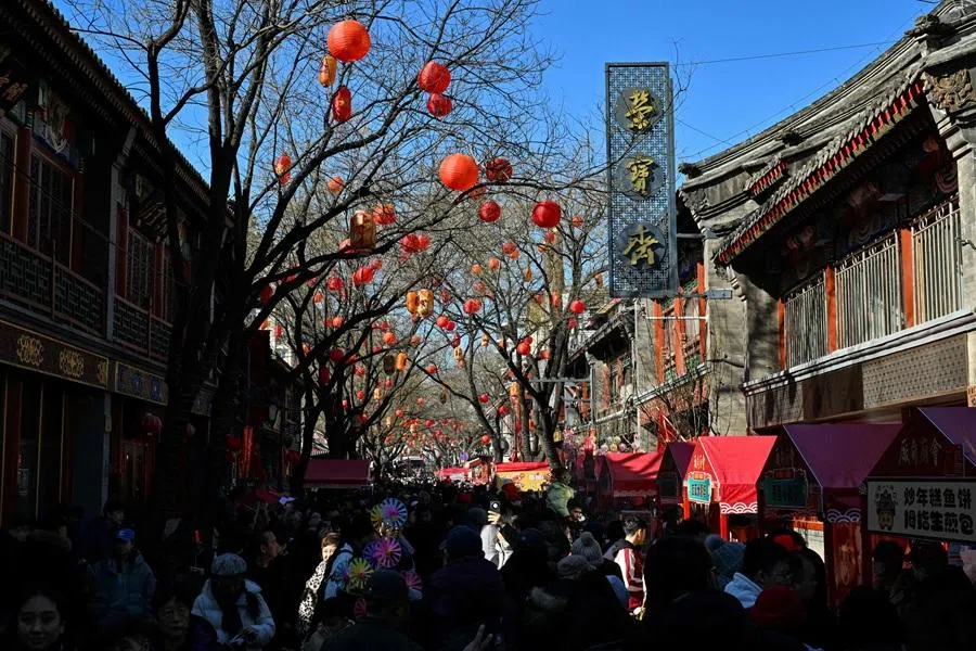 People visit a temple fair in Beijing on 18 February 2026. (Adek Berry/AFP)