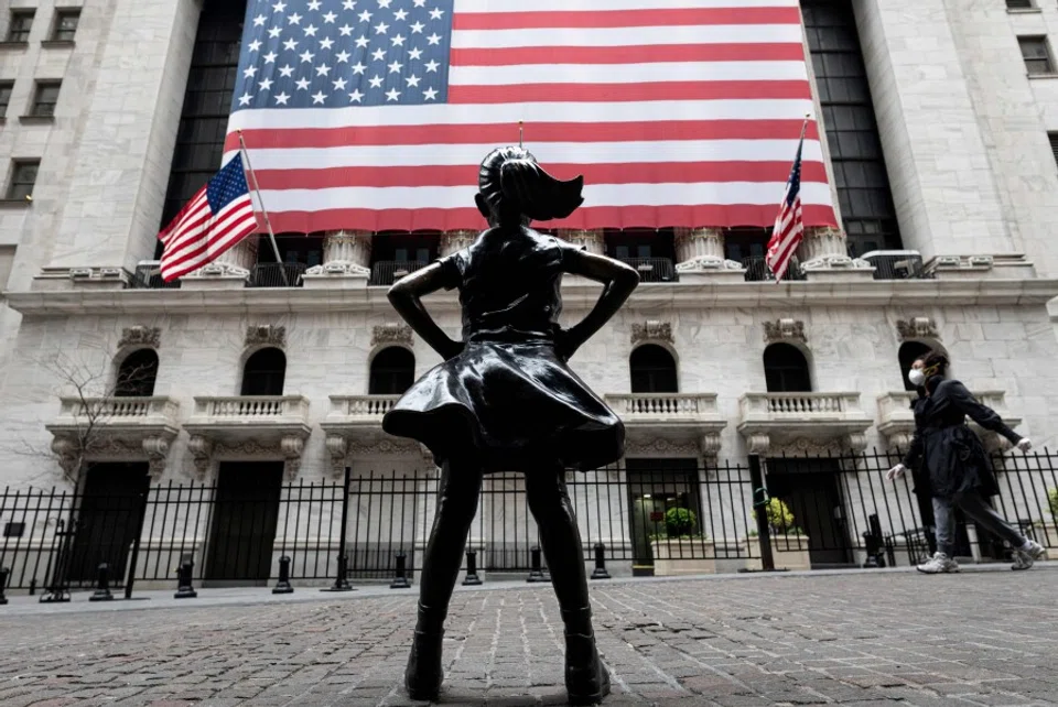 The fearless girl statue and the New York Stock Exchange (NYSE) are pictured on 20 April 2020 at Wall Street in New York City. (Johannes Eisele/AFP)