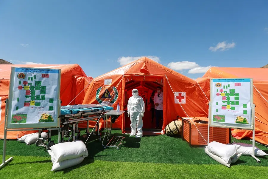 Staff members wear hazmat suits as they take part in a drill to prepare for the Covid-19 coronavirus in Ulaanbaatar, the capital of Mongolia on 7 May 2020. (Byambasuren Byamba-ochir/AFP)
