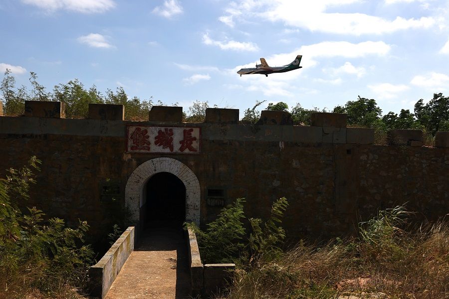 An aeroplane flies over a former military bunker towards the airport in Kinmen, Taiwan, 18 October 2021. (Ann Wang/Reuters)