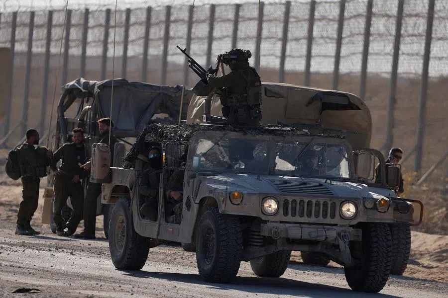 Israeli soldiers prepare before entering the Gaza Strip, amid the ongoing conflict in Gaza between Israel and Hamas, at the Kerem Shalom crossing in southern Israel, 11 November 2024. (Amir Cohen/Reuters)