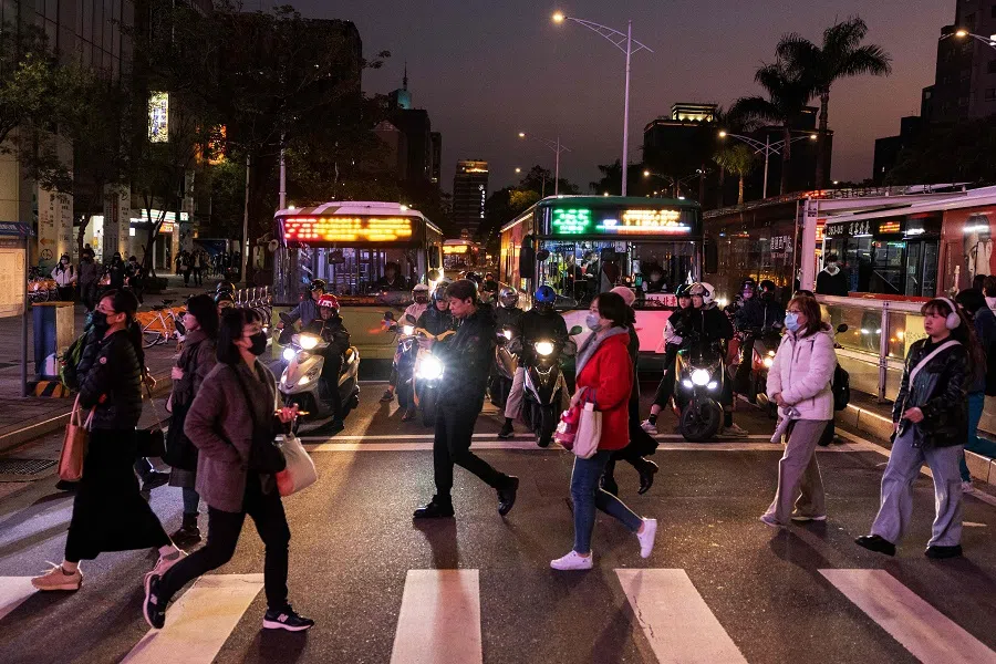 People make their way across a zebra crossing in Taipei, Taiwan, on 10 January 2024. (Alastair Pike/AFP)