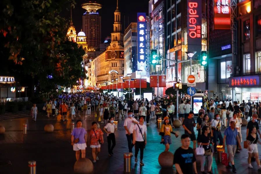 People visit a main shopping area in Shanghai, China, 12 July 2021. (Aly Song/Reuters)