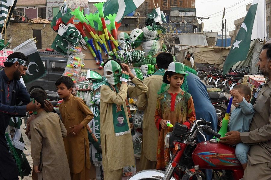 People shop in a market on the eve of Pakistan's Independence Day celebrations in Quetta, Balochistan province, Pakistan, on 13 August 2023. (Banaras Khan/AFP)