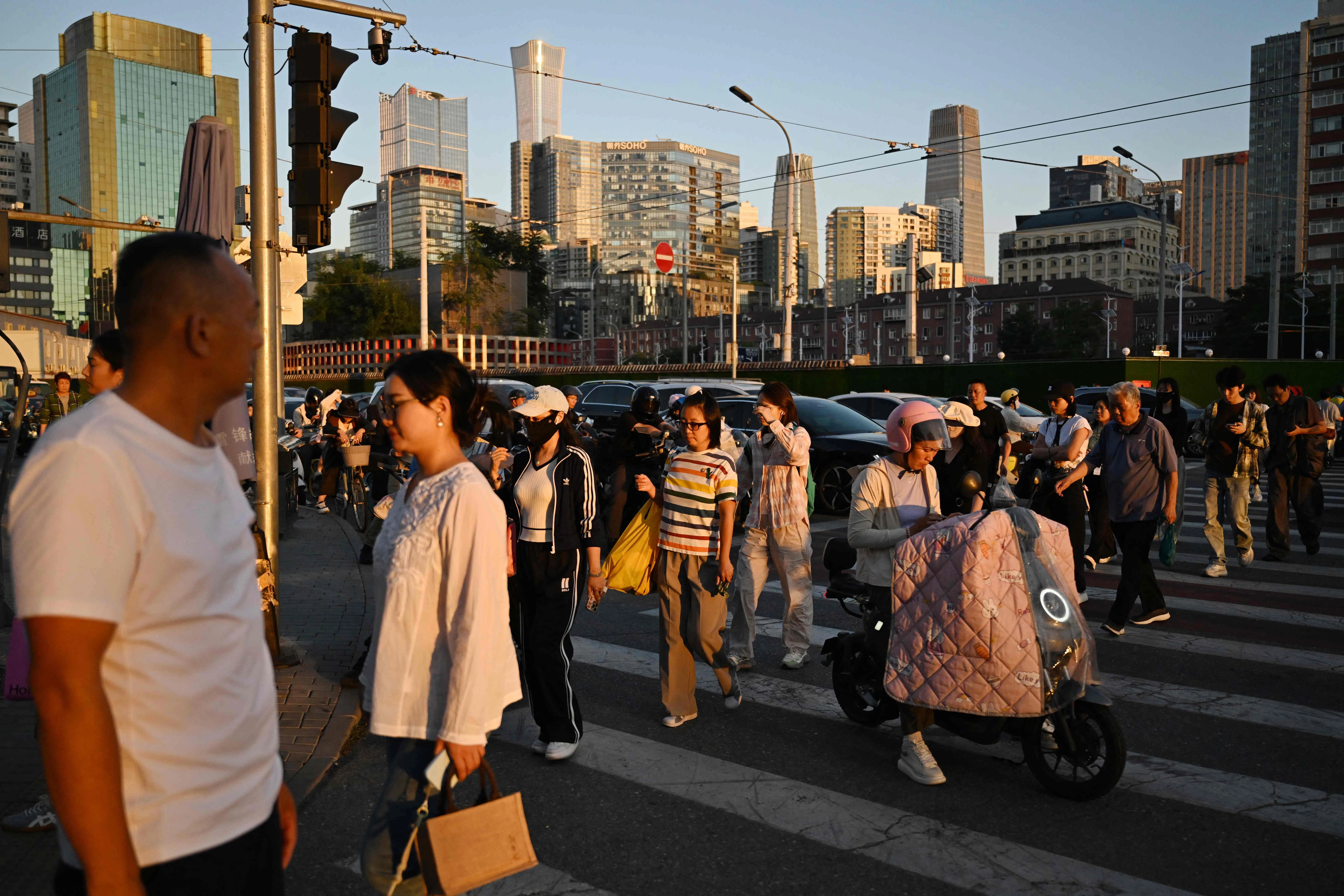 People cross a road in Beijing on 3 September 2026.