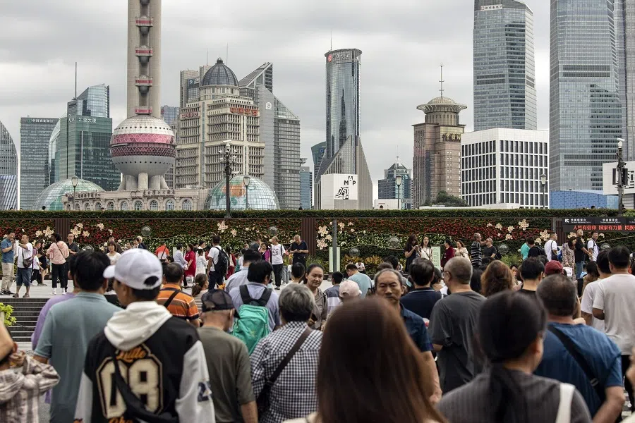 Pedestrians along the Bund in Shanghai, China, on 3 October 2023. (Bloomberg)