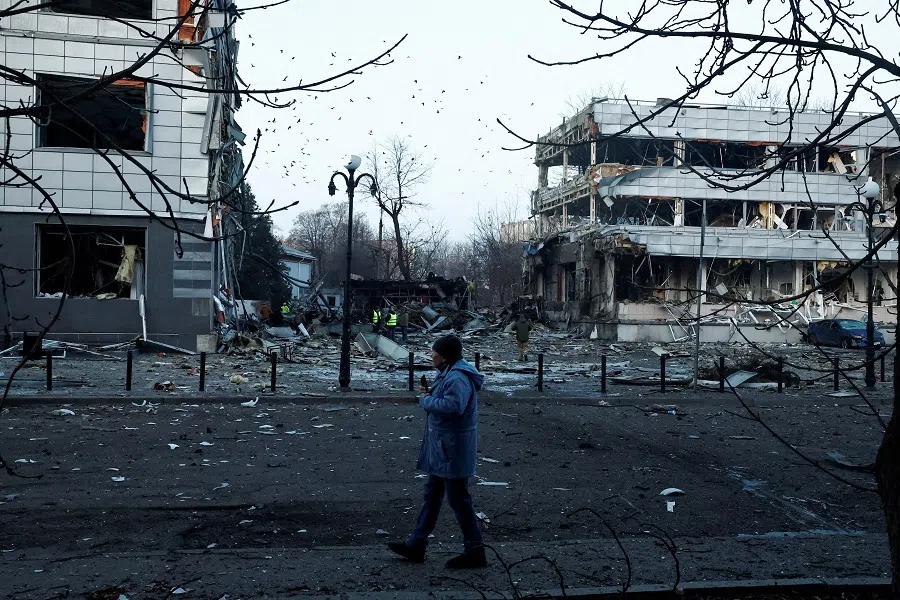 A man walks near the site of a Russian missile strike, amid Russia’s attack on Ukraine, in Kyiv, Ukraine, on 12 February 2025. (Thomas Peter/Reuters)