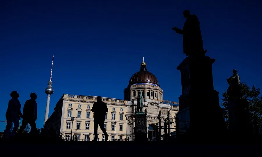 People walk past the Berlin palace which houses the Humboldt Forum, as the the TV tower (left) is seen in the background, on 10 October 2021. (John Macdougall/AFP)