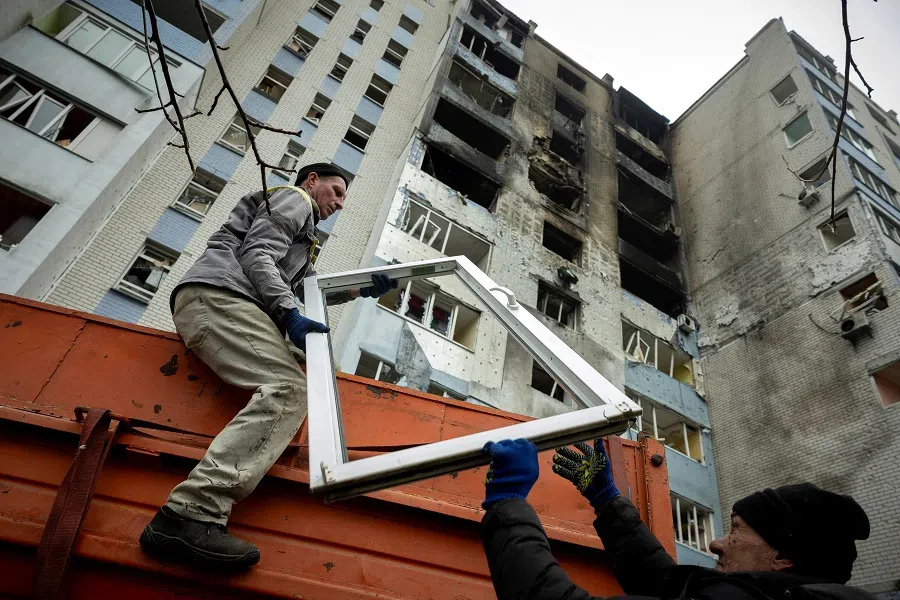 Workers remove debris from an apartment building that was struck by a Russian drone, amid Russia’s attack on Ukraine, in the town of Hlevakha, Kyiv region, Ukraine, on 24 January 2025. (Thomas Peter/Reuters)