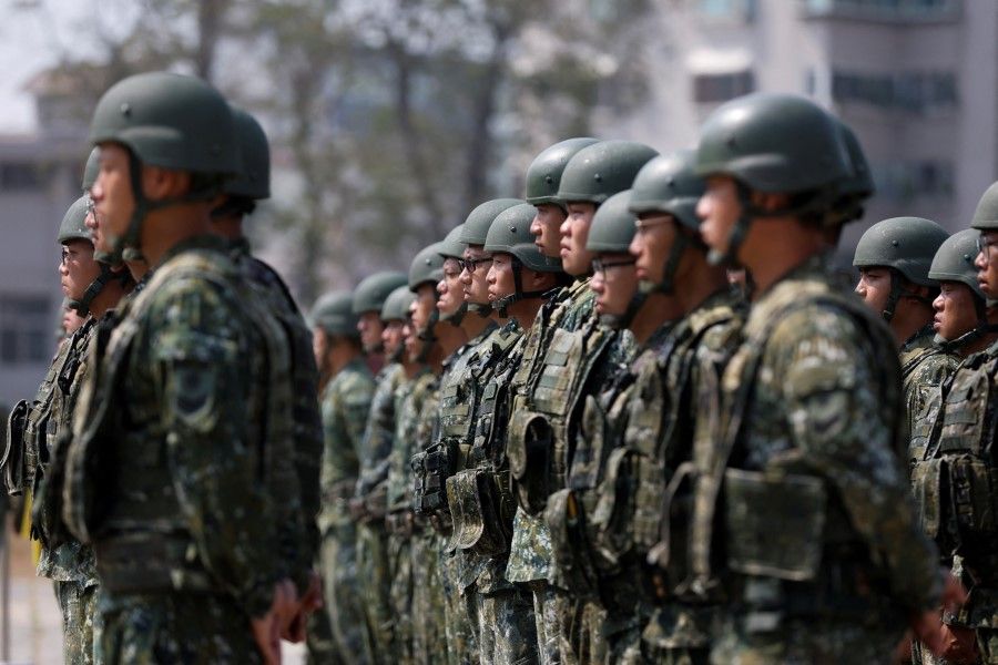 Soldiers stand in formation after the visit of Taiwanese President Tsai Ing-wen to a military base in Chiayi, Taiwan, on 25 March 2023. (Carlos Garcia Rawlins/Reuters)