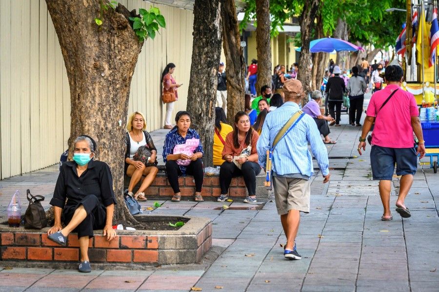 People sit on the side of a major street in Bangkok on 15 September 2020. (Mladen Antonov/AFP)