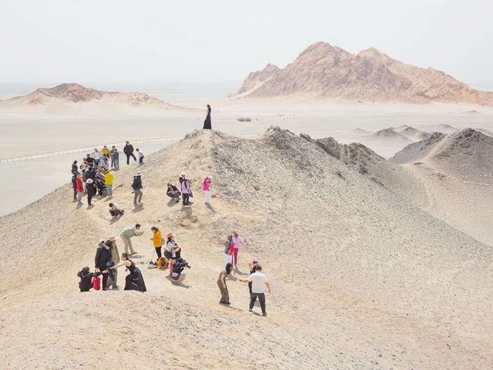 People take photos atop the mountain.