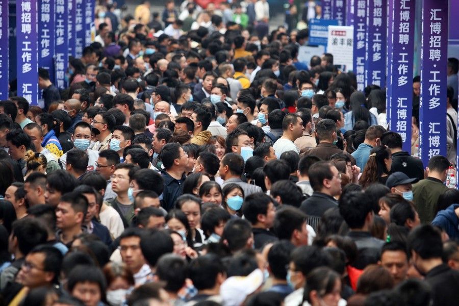 People attend a job fair in China's southwestern city of Chongqing on 11 April 2023. (AFP)