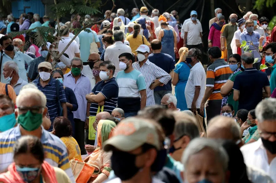 People wearing protective face masks wait to receive a vaccine for Covid-19 at a vaccination centre in Mumbai, India, 26 April 2021. (Niharika Kulkarni/Reuters)