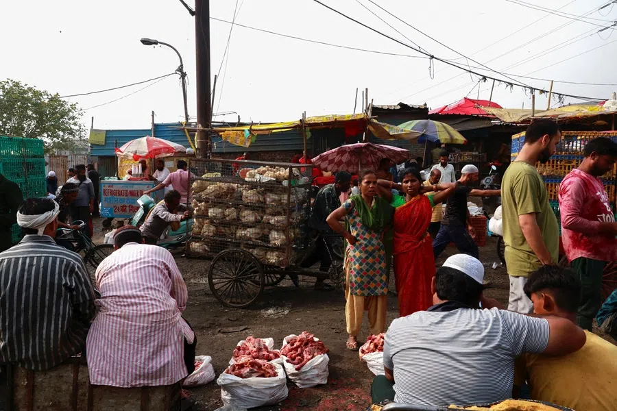 People buy meat at a wholesale meat market in New Delhi, India, on 19 May 2025. (Priyanshu Singh/Reuters)