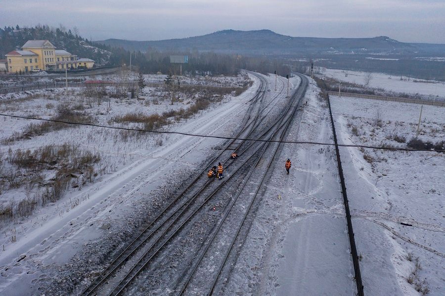 In this aerial shot taken on 11 January 2021, workers are seen maintaining the Mohe Railway Station in Mohe county, the northernmost county in China, Heilongjiang province. (Xinhua)