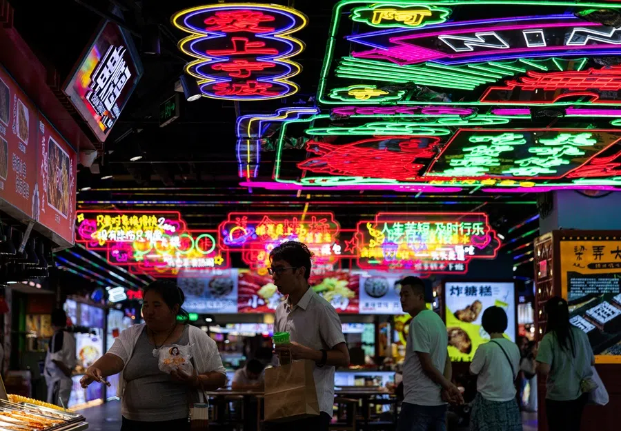 People hang out in a food court at the Gulou pedestrian street in Ningbo, Zhejiang province, China, on 16 October 2025. (Maxim Shemetov/Reuters)