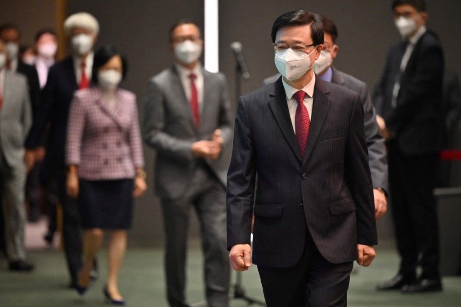 Hong Kong Chief Executive John Lee (front right) arrives for his first weekly press conference with Executive Council non-official members at the government headquarters in Hong Kong on 5 July 2022. (Peter Parks/AFP)