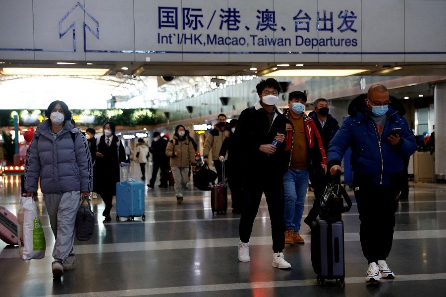 Travellers walk with their luggage at Beijing Capital International Airport, amid the Covid-19 outbreak in Beijing, China, 27 December 2022. (Tingshu Wang/File Photo/Reuters)