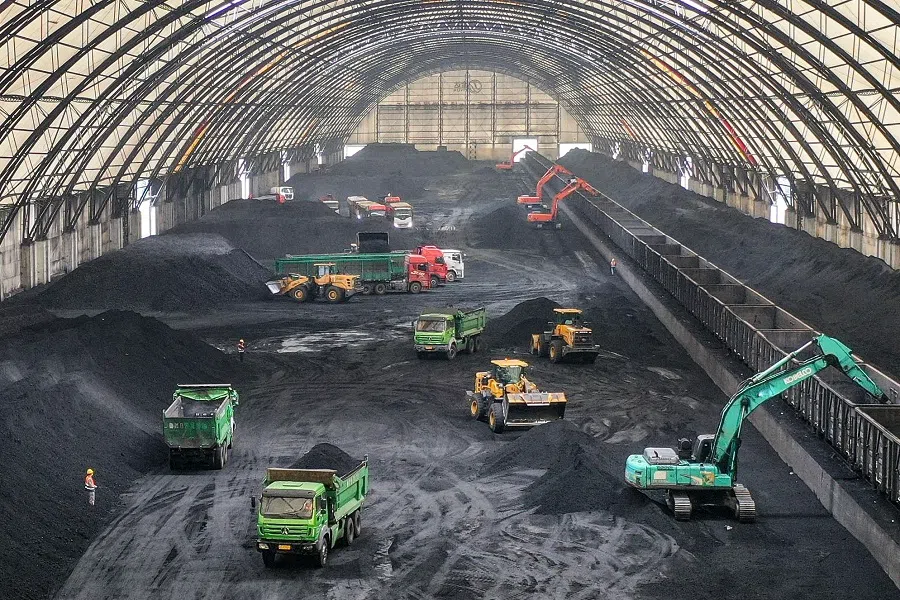 Excavators unload coal from rail cars into a coal storage facility of a logistics company in Binzhou, in eastern China’s Shandong province on 9 May 2025. (AFP)