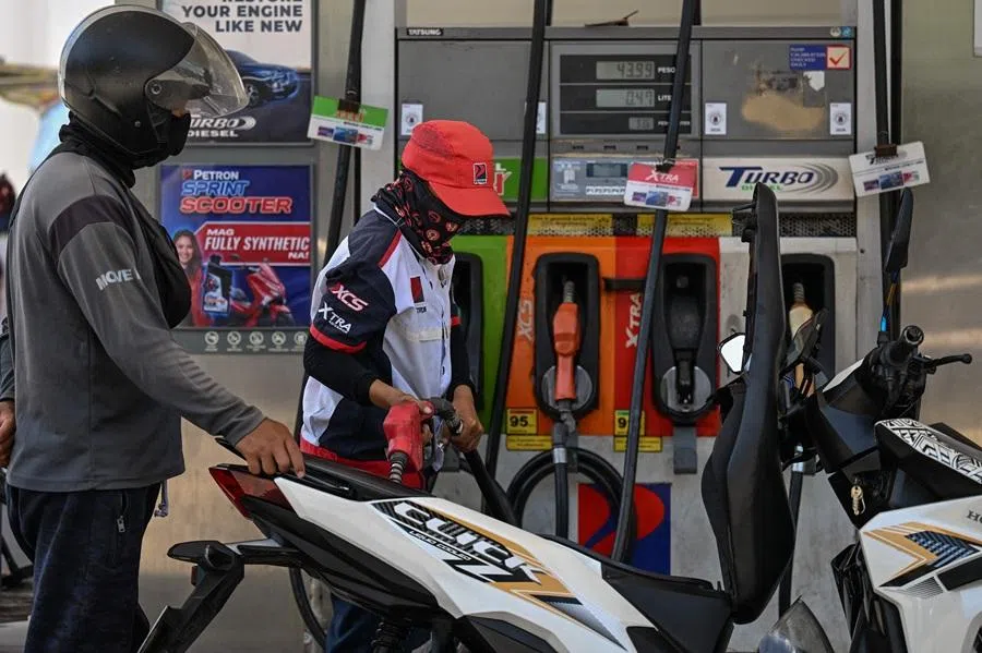 A man refuels the tank of a motorcycle at a petrol station in Manila on 7 April 2026. (Jam Sta Rosa/AFP)