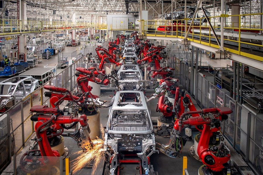 Robotic arms assemble cars in the production line for Leapmotor's electric vehicles at a factory in Jinhua, Zhejiang province, China, 26 April 2023. (China Daily via Reuters)
