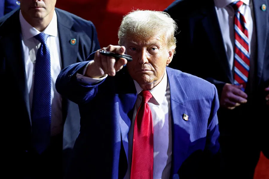 Former US President and Republican presidential candidate Donald Trump points to the crowd as he leaves after speaking during a town hall meeting in La Crosse, Wisconsin, on 29 August 2024. (Kamil Krzaczynski/AFP)