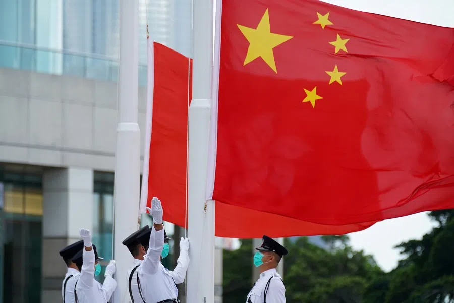 Members of the Hong Kong Police Honour Guard raise flags during a flag-raising ceremony marking China's National Day at Golden Bauhinia Square in Hong Kong, China, 1 October 2020. (Lam Yik/File Photo/Reuters)