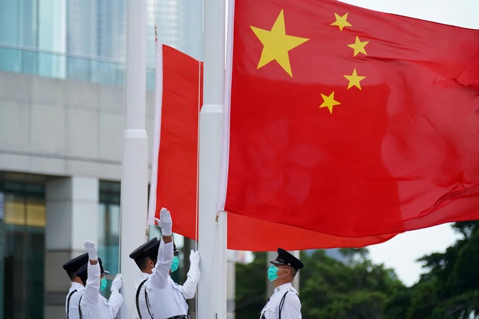 Members of the Hong Kong Police Honour Guard raise flags during a flag-raising ceremony marking China's National Day at Golden Bauhinia Square in Hong Kong, China, 1 October 2020. (Lam Yik/File Photo/Reuters)