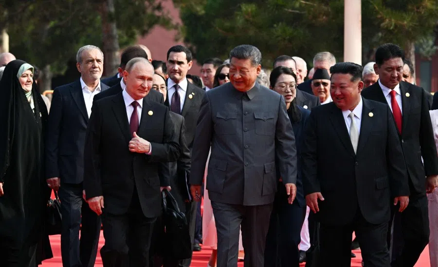 In this pool photograph distributed by the Russian state agency Sputnik, Russia’s President Vladimir Putin (left) walks with China’s President Xi Jinping (centre) and North Korea’s leader Kim Jong Un (right) before a military parade marking the 80th anniversary of victory over Japan and the end of World War II, in Beijing’s Tiananmen Square on 3 September 2025.