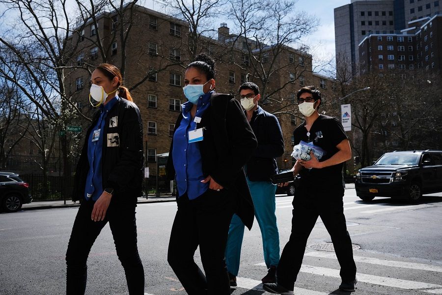 Medical workers walk outside of Mount Sinai Hospital amid the coronavirus pandemic on 01 April 2020 in New York City. (Spencer Platt/Getty Images/AFP)