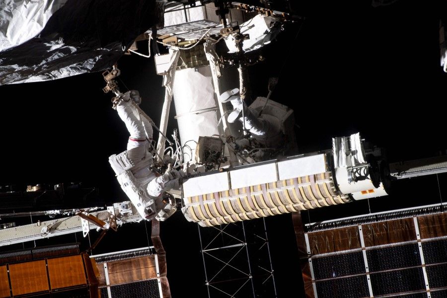 This NASA photo obtained 20 June 2021 shows Expedition 65 flight engineer Thomas Pesquet (left) of ESA (European Space Agency) attached to an articulating portable foot restraint on the end of the Canadarm2 robotic arm carrying new roll out solar arrays towards the International Space Station's P-6 truss structure, next to US astronaut Shane Kimbrough on 16 June 2021. (Handout/NASA/AFP)