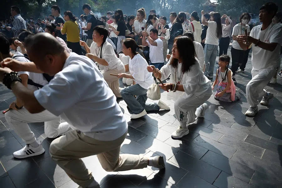 People offer prayers at the Lama Temple in Beijing, China, on 17 September 2024. (Greg Baker/AFP)