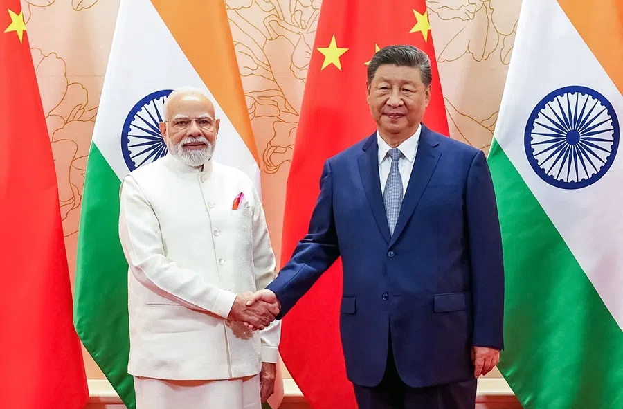 In this handout photograph taken on 31 August 2025 and released by the Indian Press Information Bureau (PIB), India’s Prime Minister Narendra Modi and China’s President Xi Jinping shake hands during a bilateral meeting on the sidelines of the Shanghai Cooperation Organisation (SCO) summit in Tianjin. (Indian Press Information Bureau/AFP)