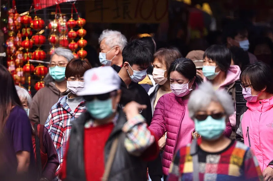 People shop while wearing a protective mask ahead of the Lunar New Year holiday in Taipei, Taiwan, 10 February 2021. (Ann Wang/Reuters)